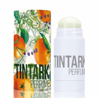 Parfum en stick avec emballage décoré de fruits.